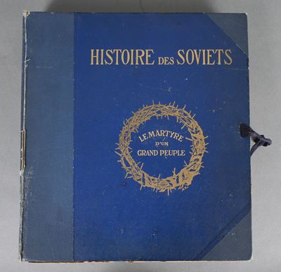 an old blue book with a crown of thorns on top of it