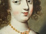 portrait of a woman in a black dress with a red and gold necklace