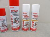 three sprays of spray paint sitting next to each other on a table