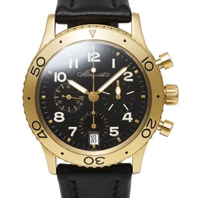 a close up of a black and gold watch on a white background