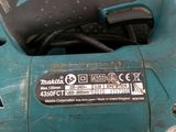 an image of a corded sander sitting on top of a table