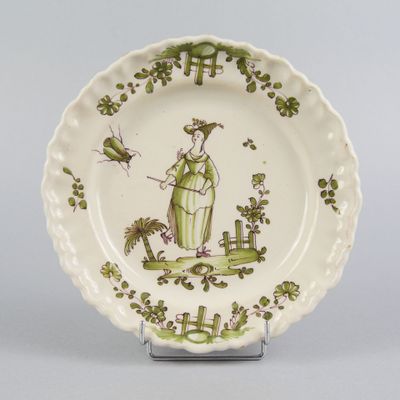 an image of a plate with a lady in a garden