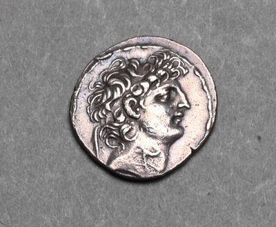 a close up of a silver coin with a man ' s head on it