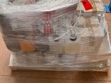 a pile of items wrapped in plastic sitting on a pallet