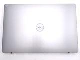 dell laptop computer sitting on a white surface with a dell logo on the screen