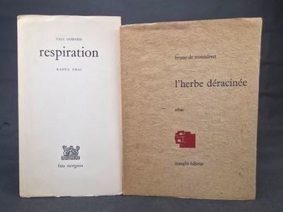 an old book sitting open on a table next to another book