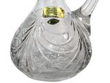 a clear glass pitcher with a gold label on it