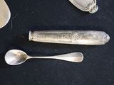 three spoons and a spoon rest on a table