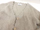 a close up of a sweater with buttons on it