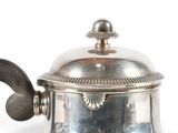 a silver tea pot with a handle on a white background