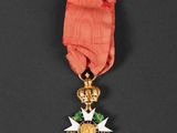 a close up of a medal with a red ribbon on a black background