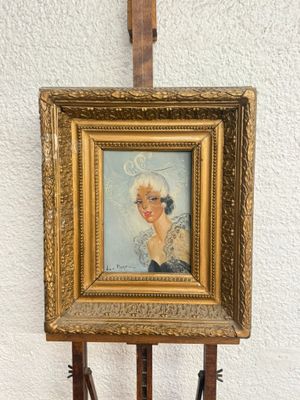 painting of a woman in a white hat on a wooden easel