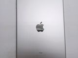 an apple ipad sitting on top of a white table next to a white wall