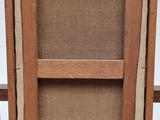 an old wooden easel with a piece of cardboard on top of it