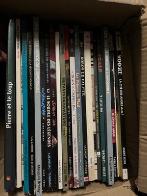 a box full of books that are sitting on the floor