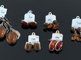 several pieces of jewelry on a black surface with price tags