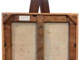 an old wooden easel with two canvass and a piece of wood