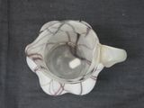a white cup with a red design on it