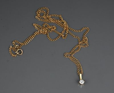 a gold necklace with a diamond on a chain