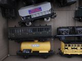 several toy trains are lined up in a box on the floor