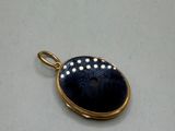 a close up of a pendant on a white surface