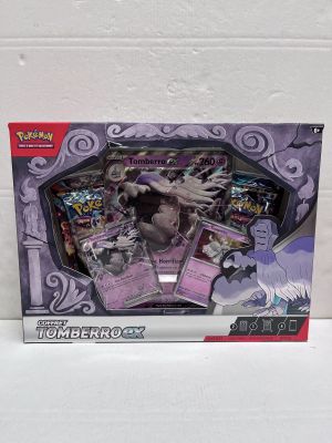 une boîte de cartes Pokémon posée sur une table blanche