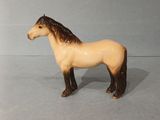 a small toy horse that is standing on a table