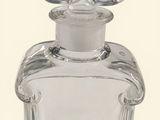 a clear glass bottle with a silver lid