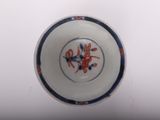 a white bowl with a blue and orange design on it