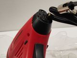 a red and black corded drill and a black and white cord