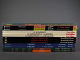 several books are stacked on top of each other on a table