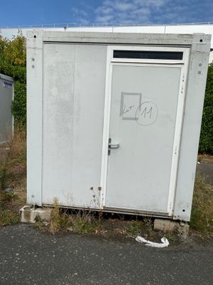 two toilets sitting in the middle of the road
