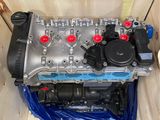 a small engine in a wooden box on a blue sheet