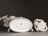 two figurines of a fish and a fish on a table
