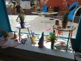 a table with a lot of things on it in front of a window