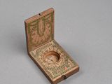 wooden box with a compass in it on a gray surface
