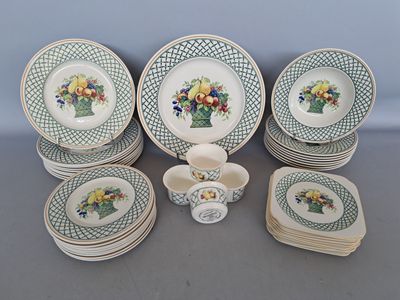 many plates and cups with flowers on them on a table
