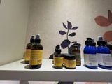 many bottles of skin care products sitting on a shelf