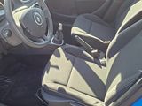 the interior of a blue car with a steering wheel and dashboard