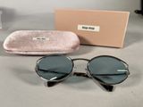 the sunglasses are sitting on the table next to the case