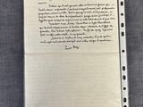 a piece of paper with writing on it sitting on top of a table
