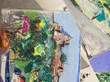 a person that is painting on a table with a brush