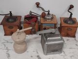 many different types of coffee grinders on a table
