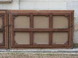 two old wooden windows on the side of a building