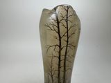 a glass vase with a picture of a tree on it