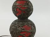 an image of a red and black lamp sitting on top of a table