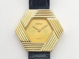 an image of a gold plated wrist watch with a black leather strap