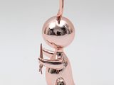 an image of a pink and gold figurine of a person holding a knife