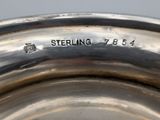 a close up of a silver plate with the word sterling on it
