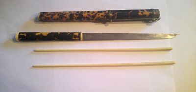 three different types of knives on display on a table